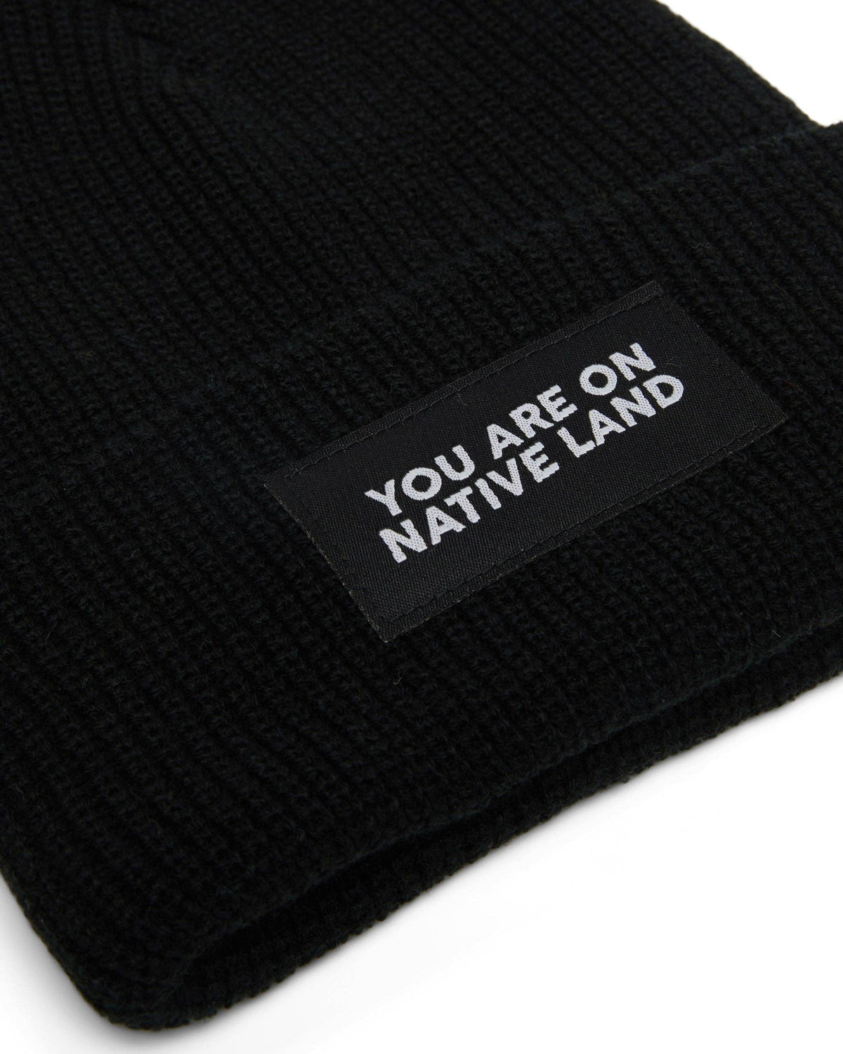 'YOU ARE ON NATIVE LAND' RIBBED BEANIE - BLACK