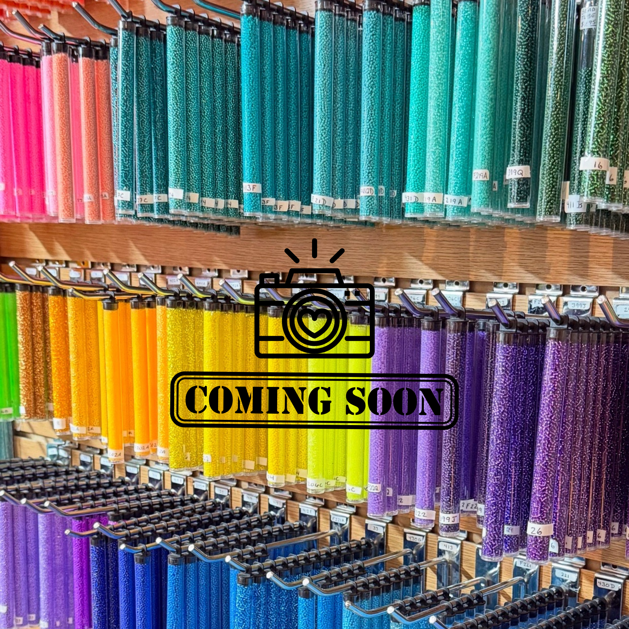 Display of colorful tubes of beads with 'Photo Coming Soon' sign